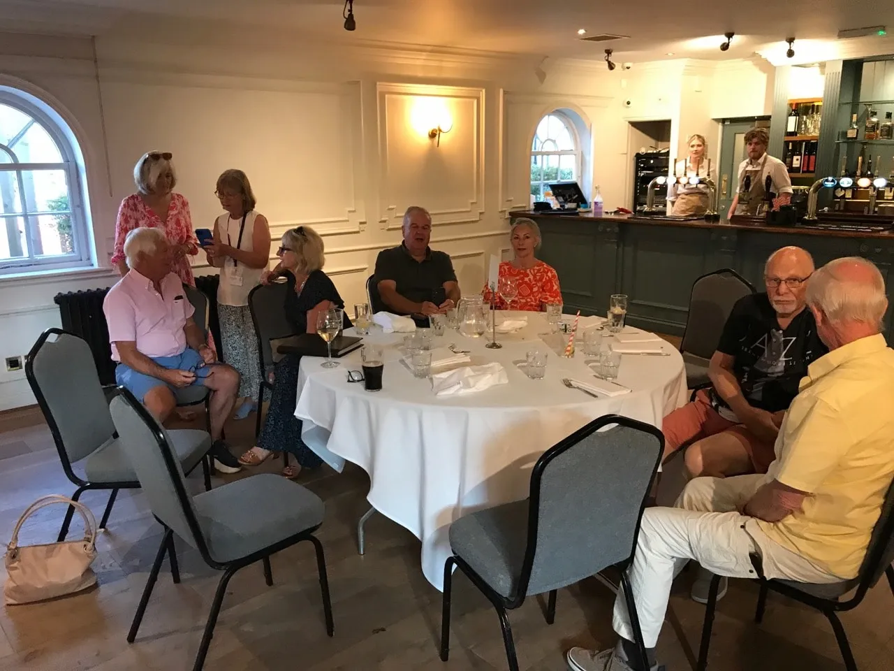 Members around a table at a club night at The Wellington Arms